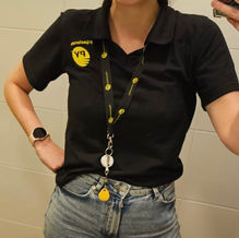 Chomba negra con logo bordado de Fijaciones PY usada por empleada – uniforme corporativo diseñado por VA ESTUDIO.