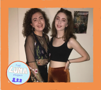 Mizz and Ally are at a party and stood together smiling. The photo has an orange border and the LUNA logo in the bottom left.
