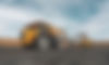 Large quarry dump truck. Big yellow mining truck at work site. Loading coal into body truc