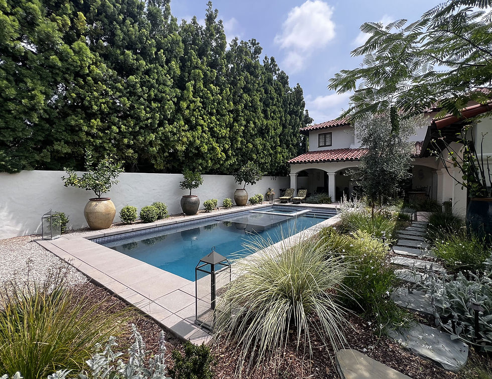 Mediterranean-inspired backyard design with pool, stone hardscape, and lush drought-tolerant plantings by Sacred Space Garden Design in San Marino