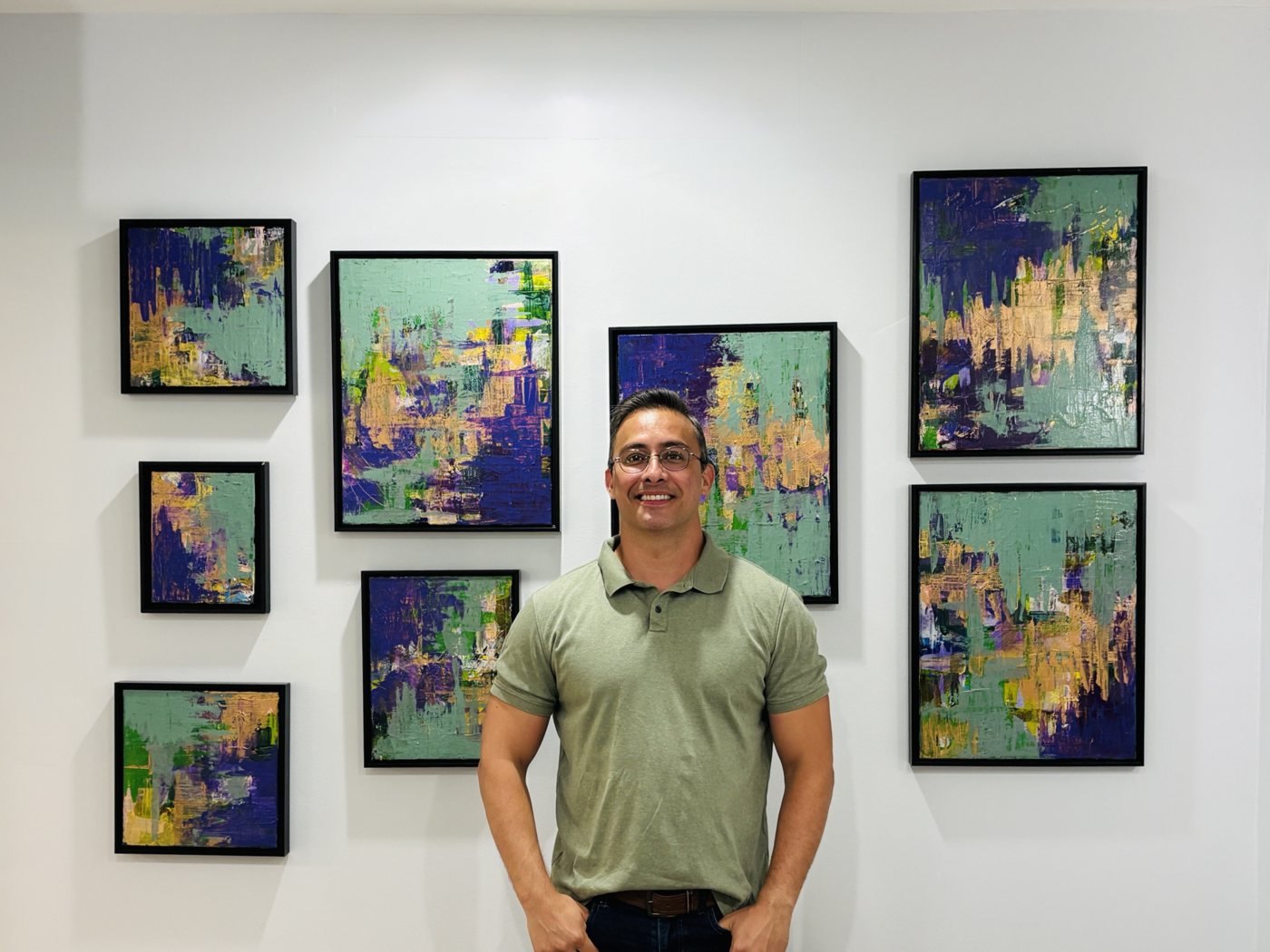 Edward in front of the eight Purple Clover paintings hung as a group