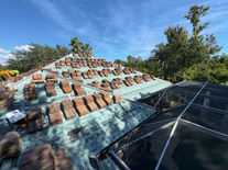 Tiled roof installation with new tiles and screened pool enclosure