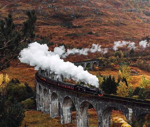 Jacobite steam train crossing Glenfinnan Viaduct, Scottish Highlands
