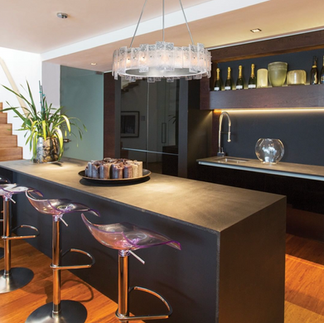 lunea round studio glass pendant above a breakfast bar