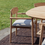 Thumbnail: outdoor terrace featuring the Leandro outdoor dining arm chair in teak with seat cushion