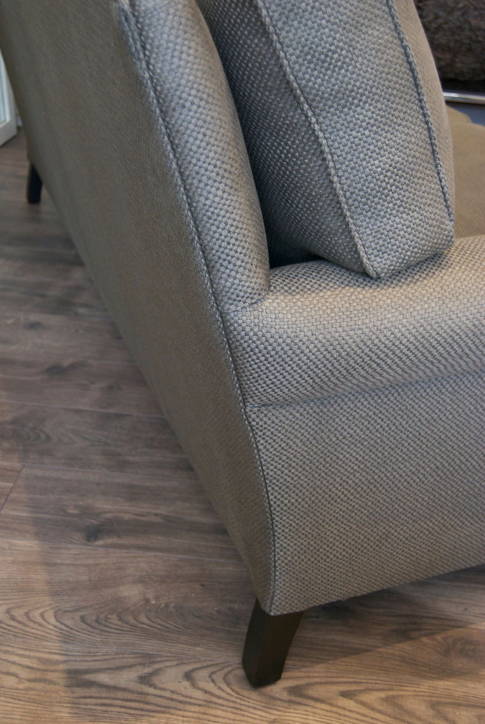 Thumbnail: close up of the side view of the Wilburn sofa and wooden leg