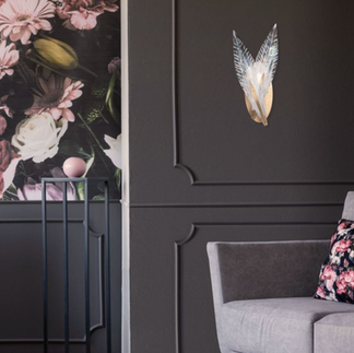 plumes wall light featuring dichroic glass feathers