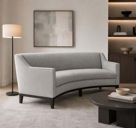 Courtyard round sofa with timber tapered legs base and upholstered body. in contemporary living room setting.