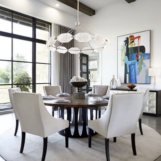 Allison paladino dichroic glass round pendant above a round dining table