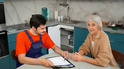 male-plumber-working-with-client-fix-kitchen-problems1.jpg