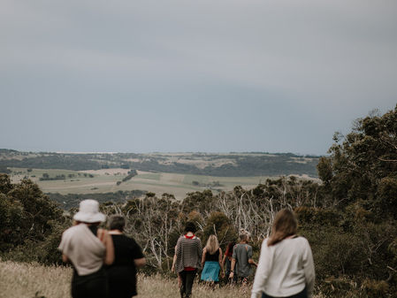 Women walking down a hill with Australian countryside in the background