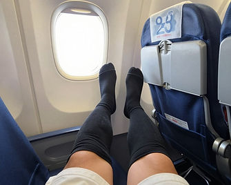 Travel passenger wearing compression socks on airplane