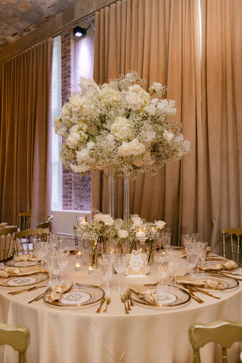 Elegant table setting with large white floral arrangement for special event.