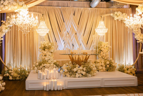 Elegant wedding stage with flowers, chandeliers, and decorative elements for a ceremony