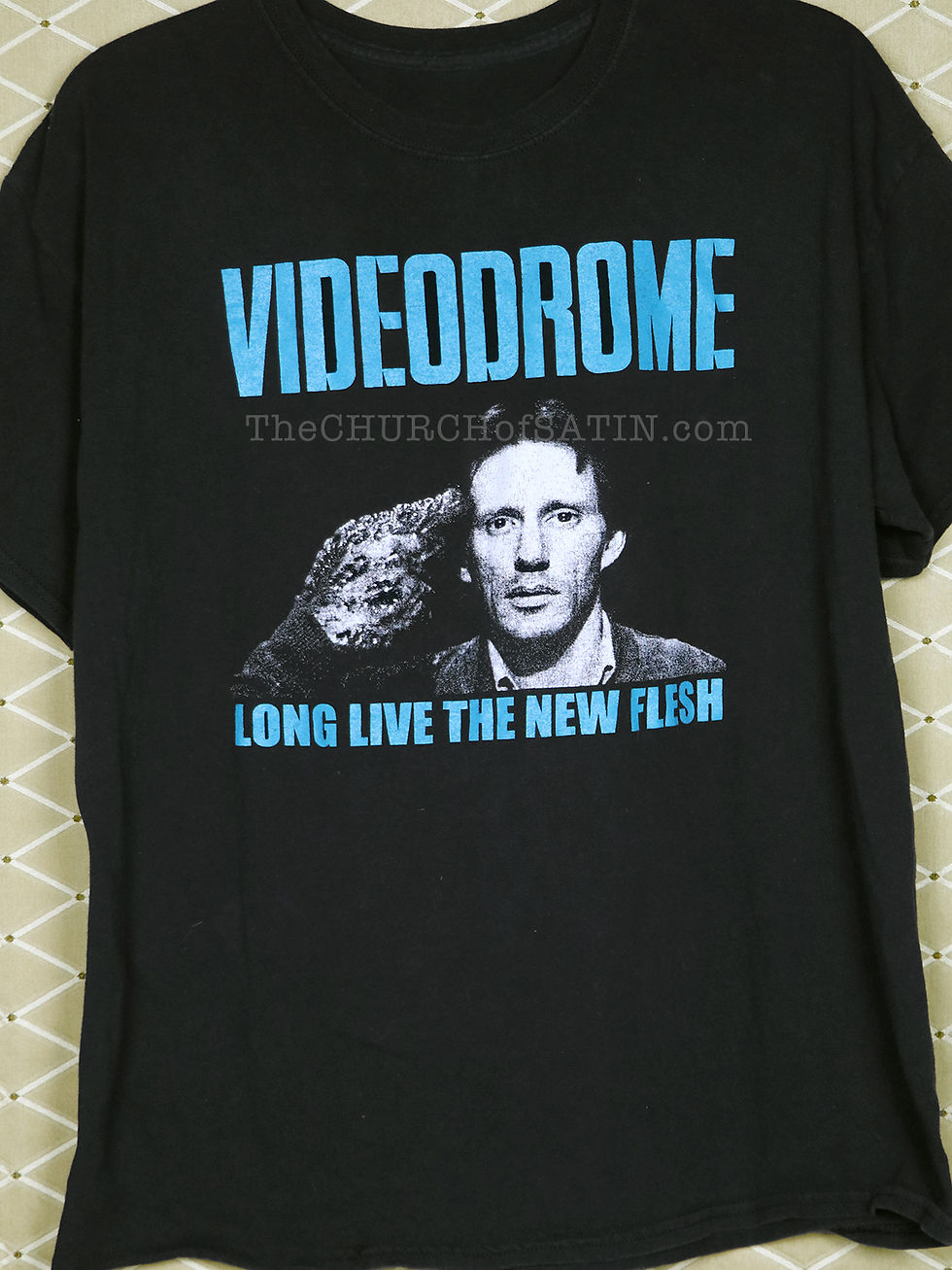 A vintage horror movie t-shirt from Videodrome depicting Max Renn (James Woods) with his body horror handgun, and the text "Long Live the New Flesh".