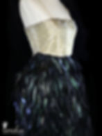 1960s or 1970s vintage couture DONALD BROOKS gown with heavily silver & gold bugle beaded bodice and iridescent black and green feathered floor length skirt.