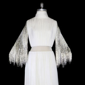 1980s Bob Mackie vintage ivory silk chiffon evening gown or wedding dress with silver and white beaded fringe sleeves.