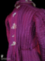 The back of a Victorian era vintage couture robe in quilted magenta silk with butterfly and flower embroidery.