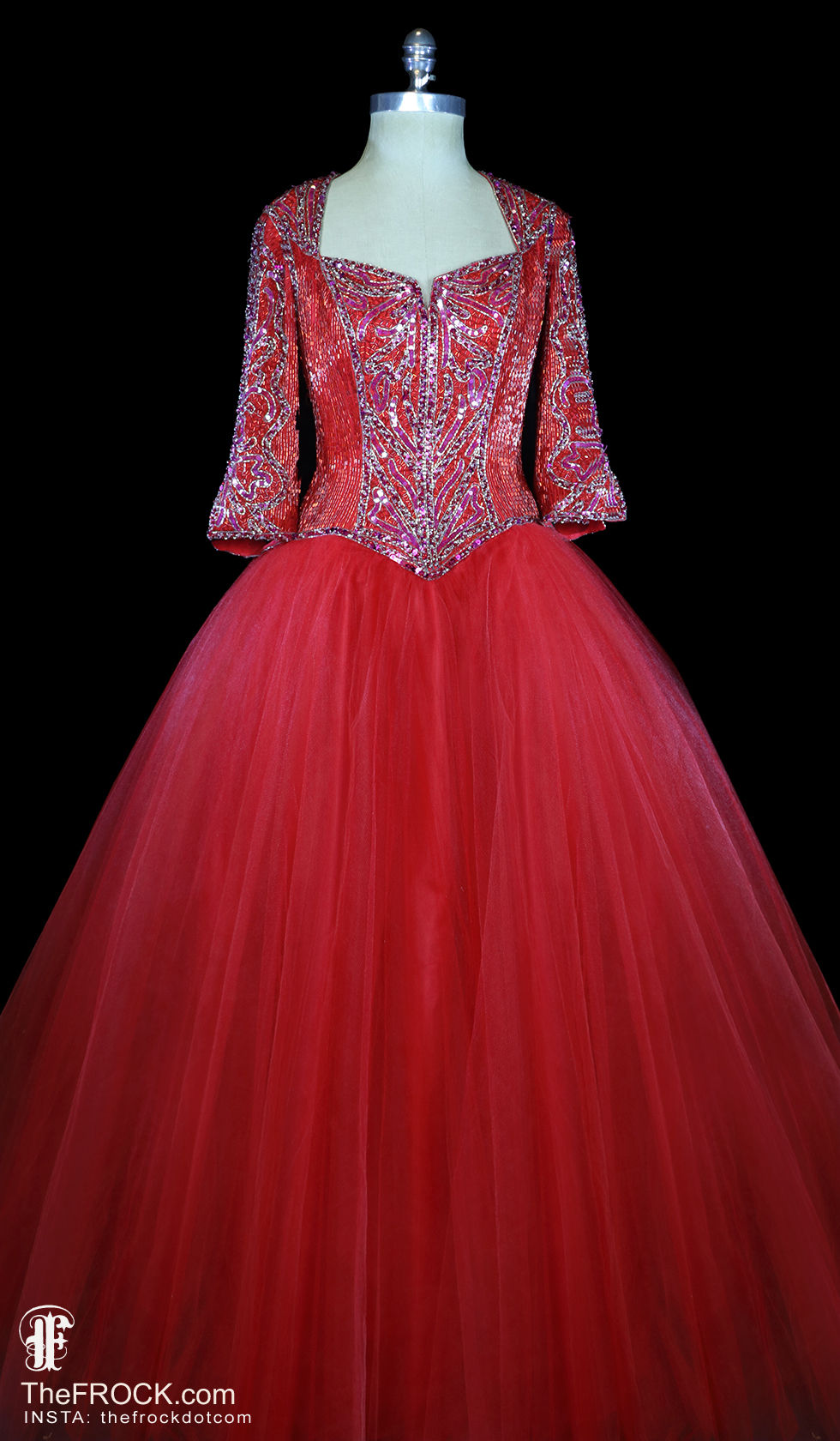 A bright red beaded bodice gown with 3/4 length sleeves and a huge tulle ballgown skirt by Bob Mackie.