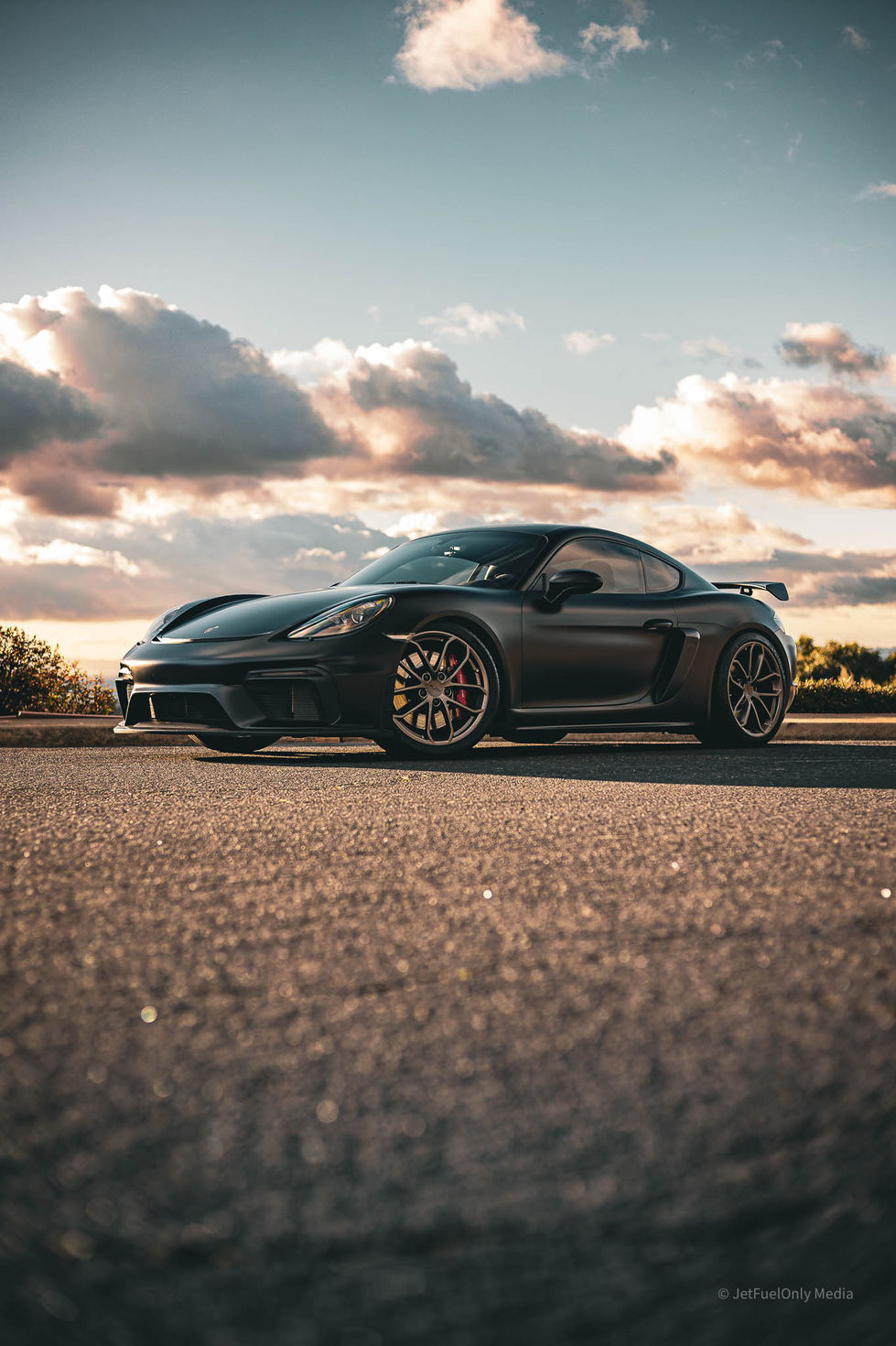 a black sports car is parked on the side of the road