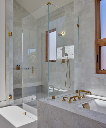 modern bathroom remodel with white zellige tile and skylights