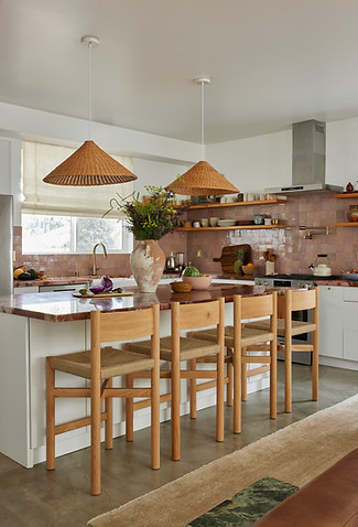 dramatic woven pendants over kitchen island with red marble counter