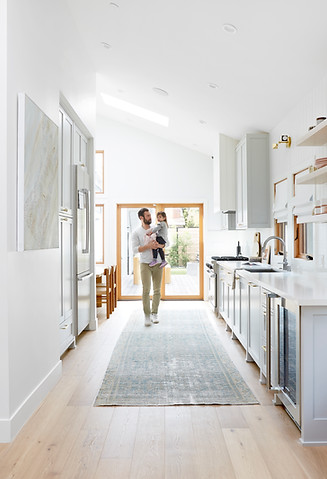 View of dad holding child in Coastal kitchen