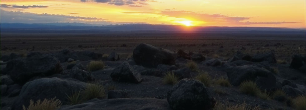 Dark rough landscape with a beautiful sunset in the distance. However bad things may feel, there is always hope.