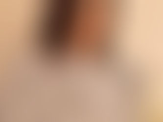 The image features a graceful woman draped in a luxurious Pashnoor shawl. The shawl is adorned with an intricate floral design in elegant shades of grey and silver, reflecting a timeless charm. Her serene expression complements the understated sophistication of the shawl. The background is neutral, allowing the delicate craftsmanship of the Pashnoor piece to stand out. The Pashnoor logo is elegantly placed in the top right corner, reinforcing the brand’s identity.