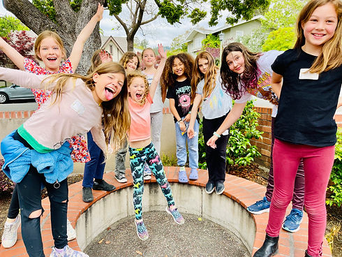 Kids smiling and having fun during lunch at Mr. D's Music Club summer camp.