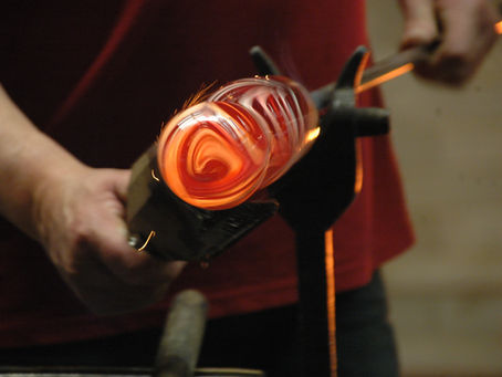 Close-up of molten glass during the glassblowing process in a workshop.