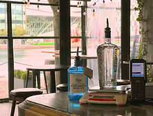 Weigh Scales with Scanner and bottles of spirits. Grand Canal Dock in the background