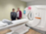 two women standing by new low-dose CT scan