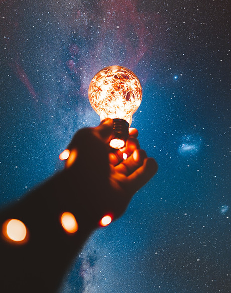 person-holding-light-bulb-with-string-lights-inside-1830252.jpg