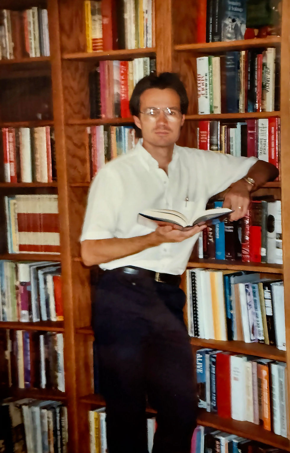 Kevin in his home library with 1,000 volumes started in 1974. He builds his specialty library on the Deaf community, probably the largest private collection on the subject in the country.