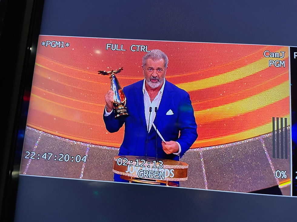 Mel Gibson holding an award on stage