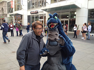 R. Michael Soo standing with Godzilla character in San Francisco