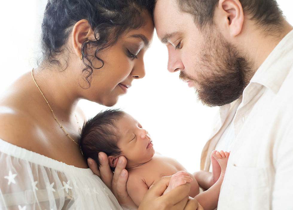 Newborn photoshoot with mom dad and baby in gentle white natural fabrics close up