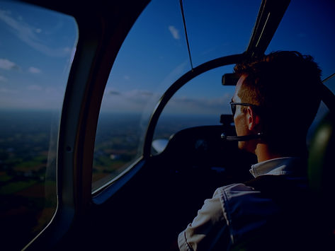 An-aspiring-pilot-in-cockpit-enjoys-sunny-weather-flying-over-countryside-under-blue-sky_e