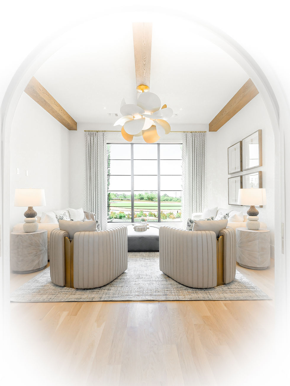 Bright luxury living room with soaring arched ceiling, exposed natural wood beams, sculptural chandelier, neutral upholstered