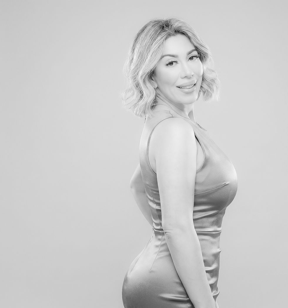 Professional portrait of Tara Nazmi, Texas real estate broker and founder of TNZ Home, posed against a soft neutral backgroun