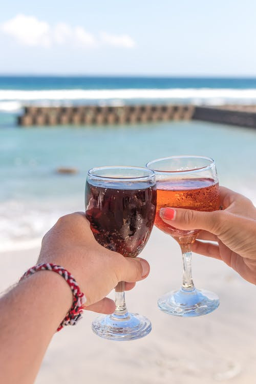 Shallow Focus Photo of Person Holding Clear Footed Wine Glass