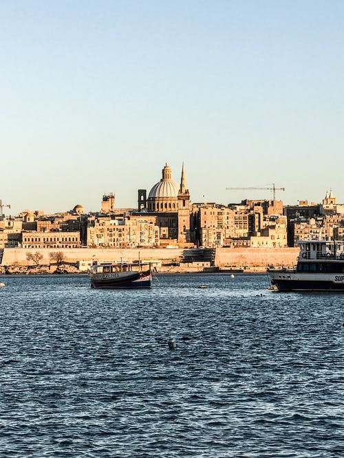 Two Ship on Body of Water Near Buildings
