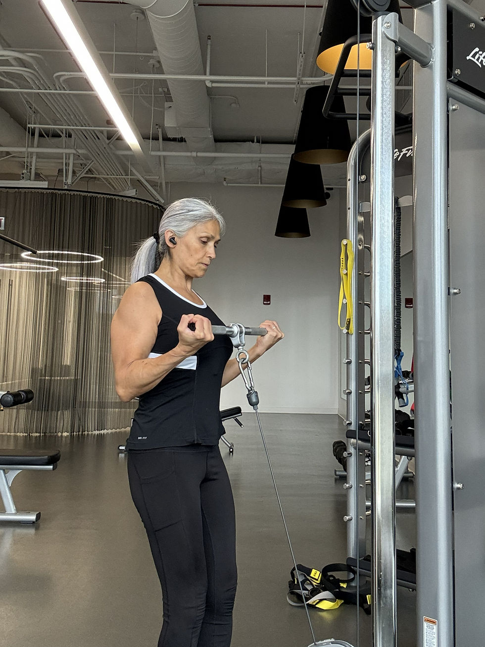 Katherine Fischer strength training at the gym with her natural silver hair