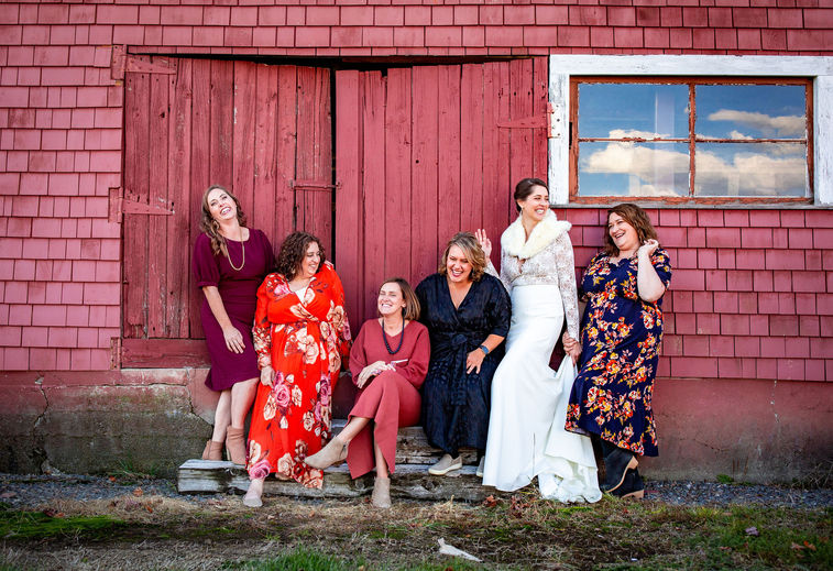Bride and Bridesmaids laughing in front of Mountain View Farm Barn Vermont.jpg