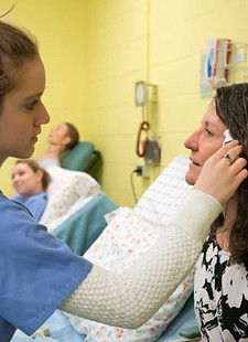 Licensed Nursing Assistant Student treating a patient.