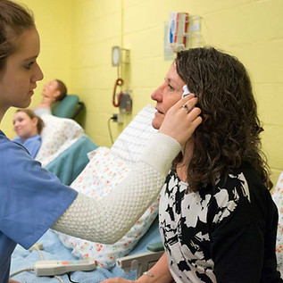 Licensed Nursing Assistant Student treating a patient.