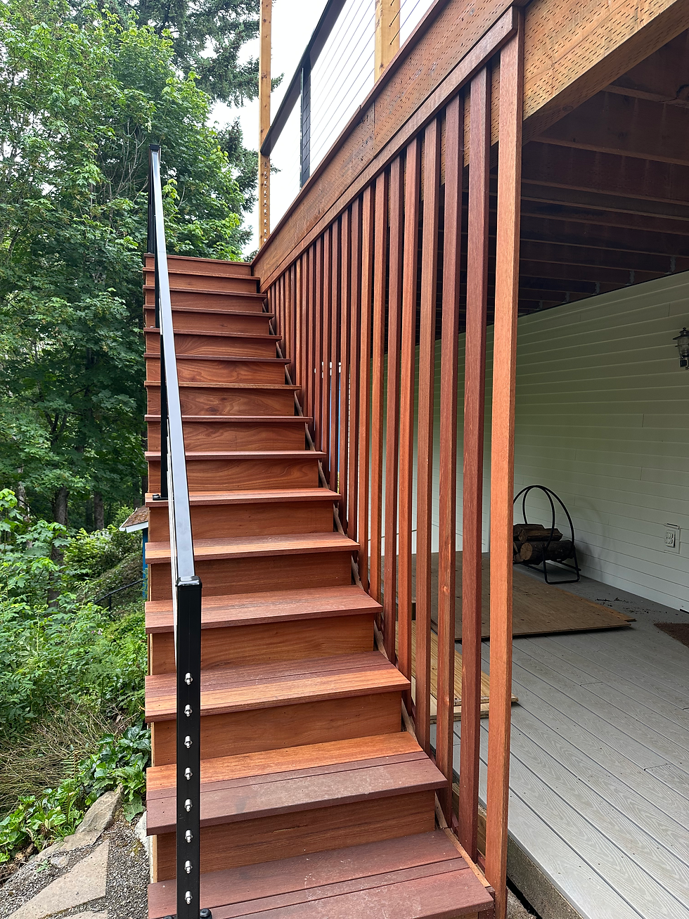 Batu hardwood deck stairs with black aluminum railing and vertical privacy screen in Portland backyard
