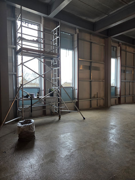 Large warehouse windows prior to window film installation with scaffold tower erected