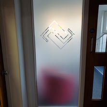 Side panel at a reception with a solid frost design with a logo etched out of the window film